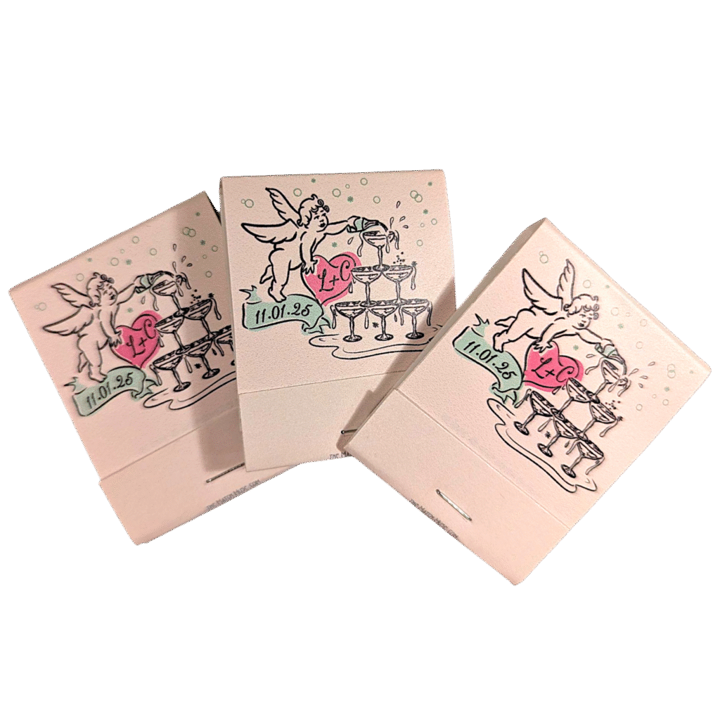 tan matchbooks with cupid pouring champagne over a tower of glasses