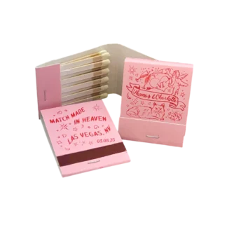 three pink wedding matchbooks with red custom illustrations